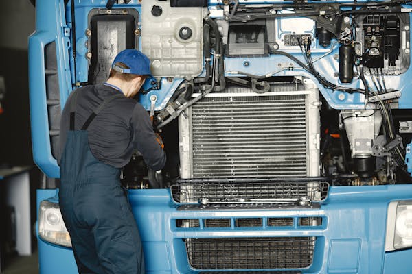 a person working on a blue truck